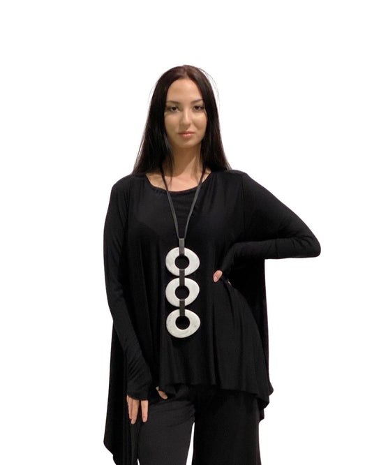 Jen Kahn 3 disc elliptical pendant in white worn on model over linen top