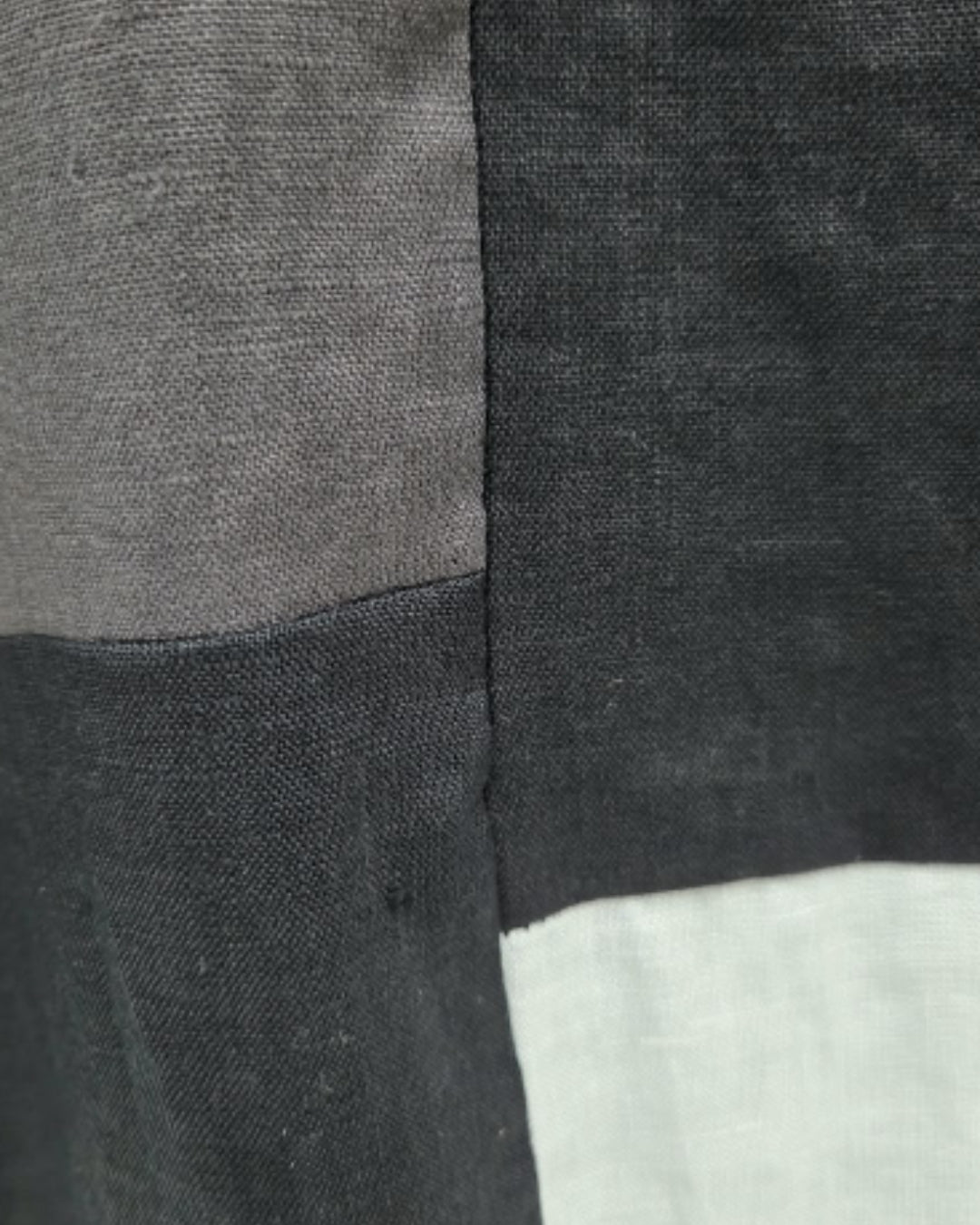 Close-up of black, charcoal grey and white pure linen colour blocking on the Jen Kahn Blocked Linen Dress