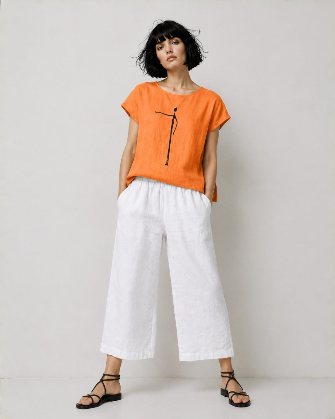 jen kahn Cave Print Linen Top in Tangerine pure linen with a contrasting cave figure print, worn on model.