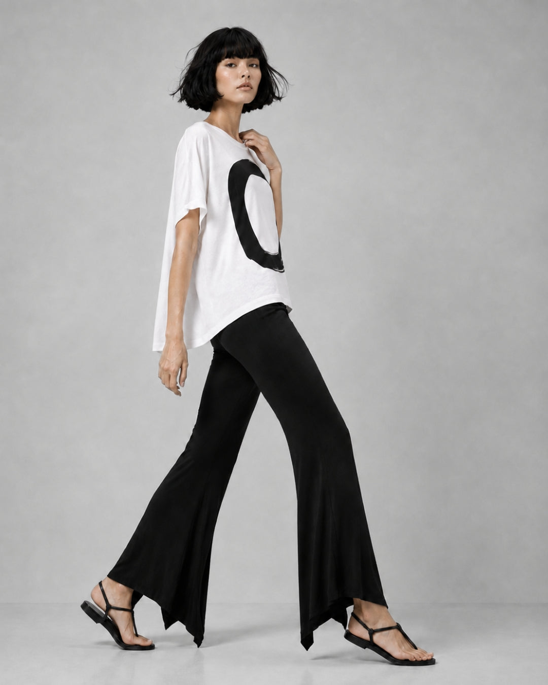 jen kahn Jersey Knit Pointed Pants in Black with a fluid flared leg and distinctive pointed hem, shown on model in side view.