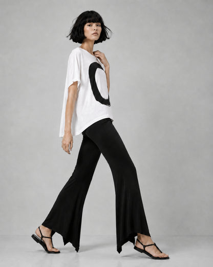 jen kahn Jersey Knit Pointed Pants in Black with a fluid flared leg and distinctive pointed hem, shown on model in side view.