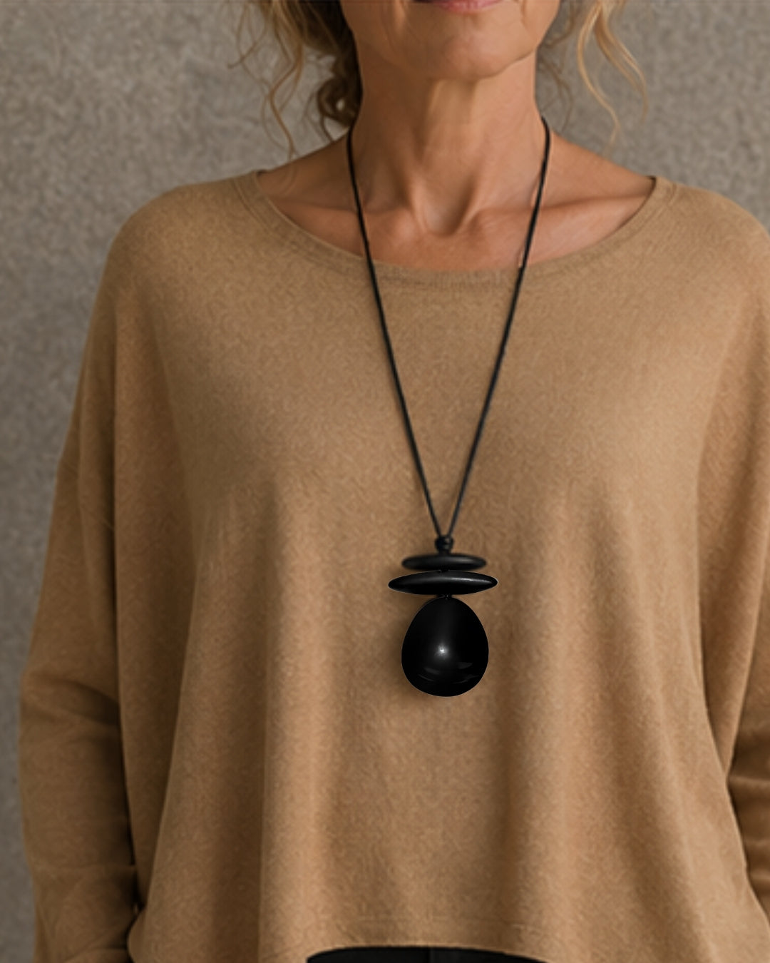 Jen Kahn leather dome pendant worn on model over jersey top
