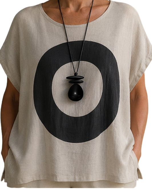 Jen Kahn leather dome pendant worn on model over linen top