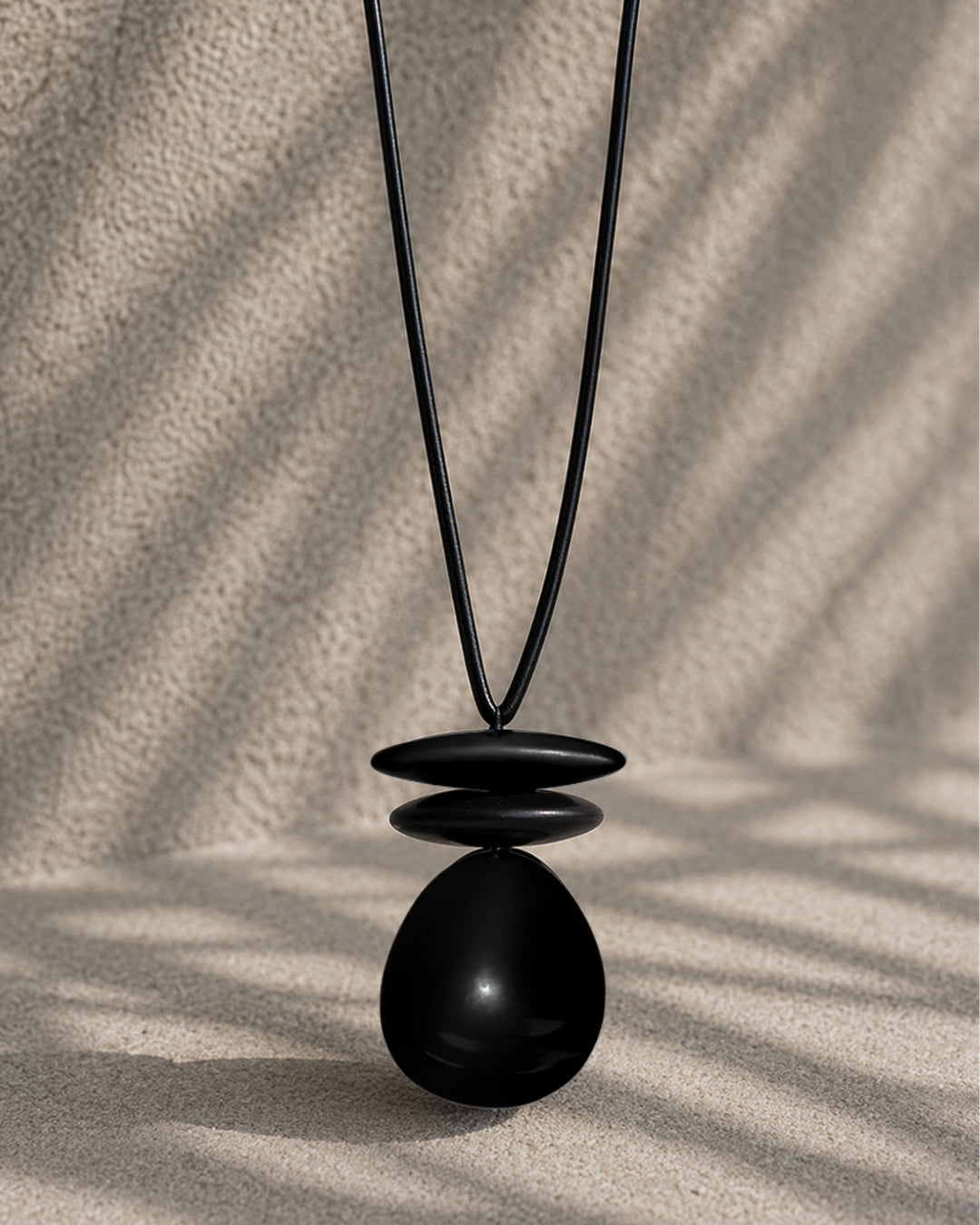 Jen Kahn leather dome pendant with black resin beads on leather cord