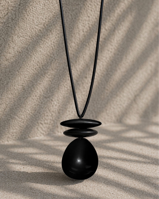Jen Kahn leather dome pendant with black resin beads on leather cord
