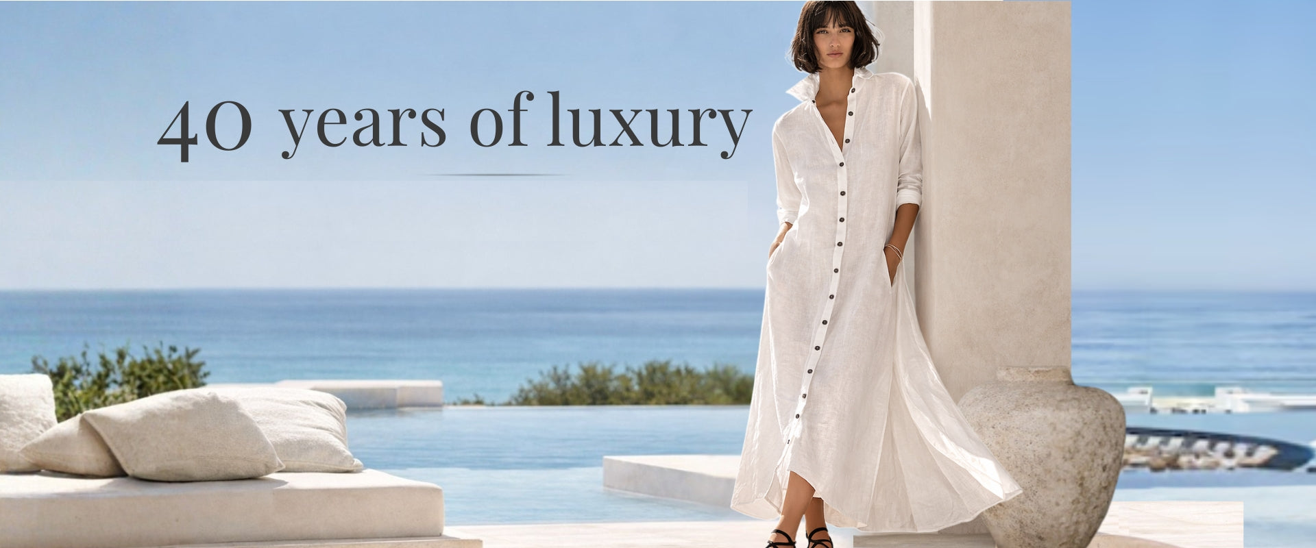 Model in white linen dress by the ocean – Jen Kahn luxury collection