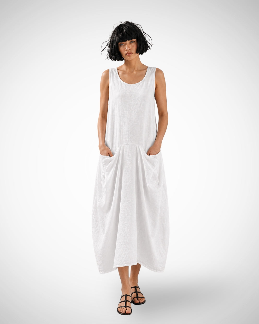 Jen Kahn Linen Sailing Dress in white pure linen with a sleeveless silhouette and distinctive inward-draped front pockets.