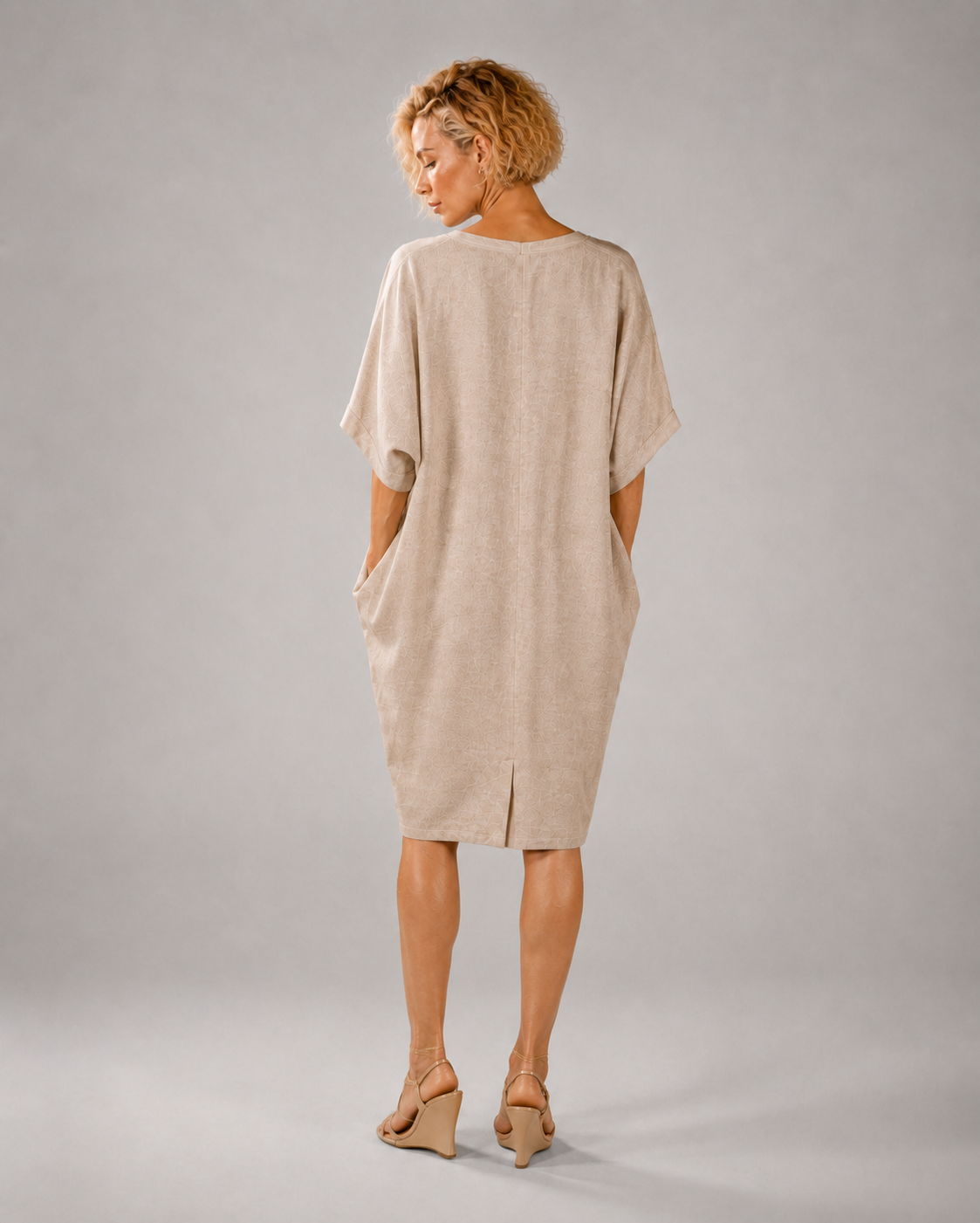 Back view of the jen kahn Linen Yachting Dress in Natural, made from pure linen with a relaxed batwing silhouette, tapered hem and centre-back slit.