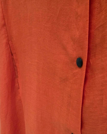 Close-up of the Jen Kahn Long Linen Shirt Dress in Tangerine, showing the natural linen texture, black button and stitched front placket.