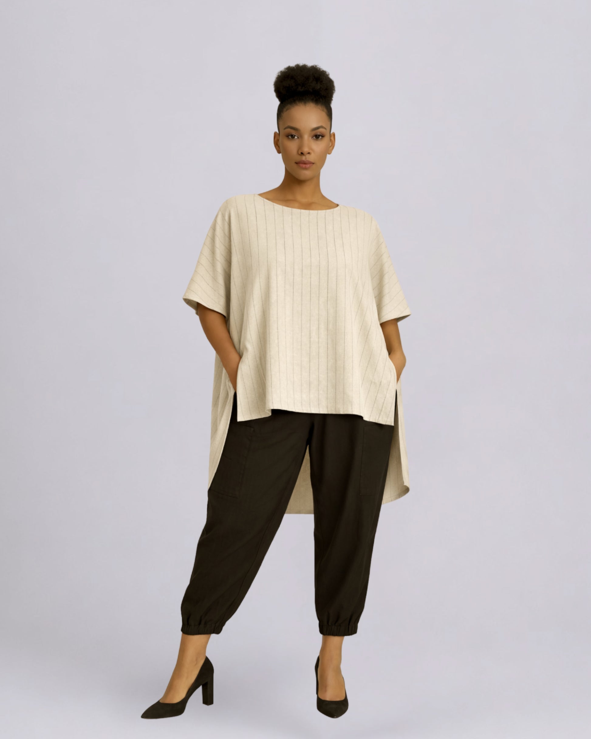 Jen Kahn Long Tokyo linen tunic worn on model in natural pinstripe with short sleeves, hidden seam pockets and longer back hem