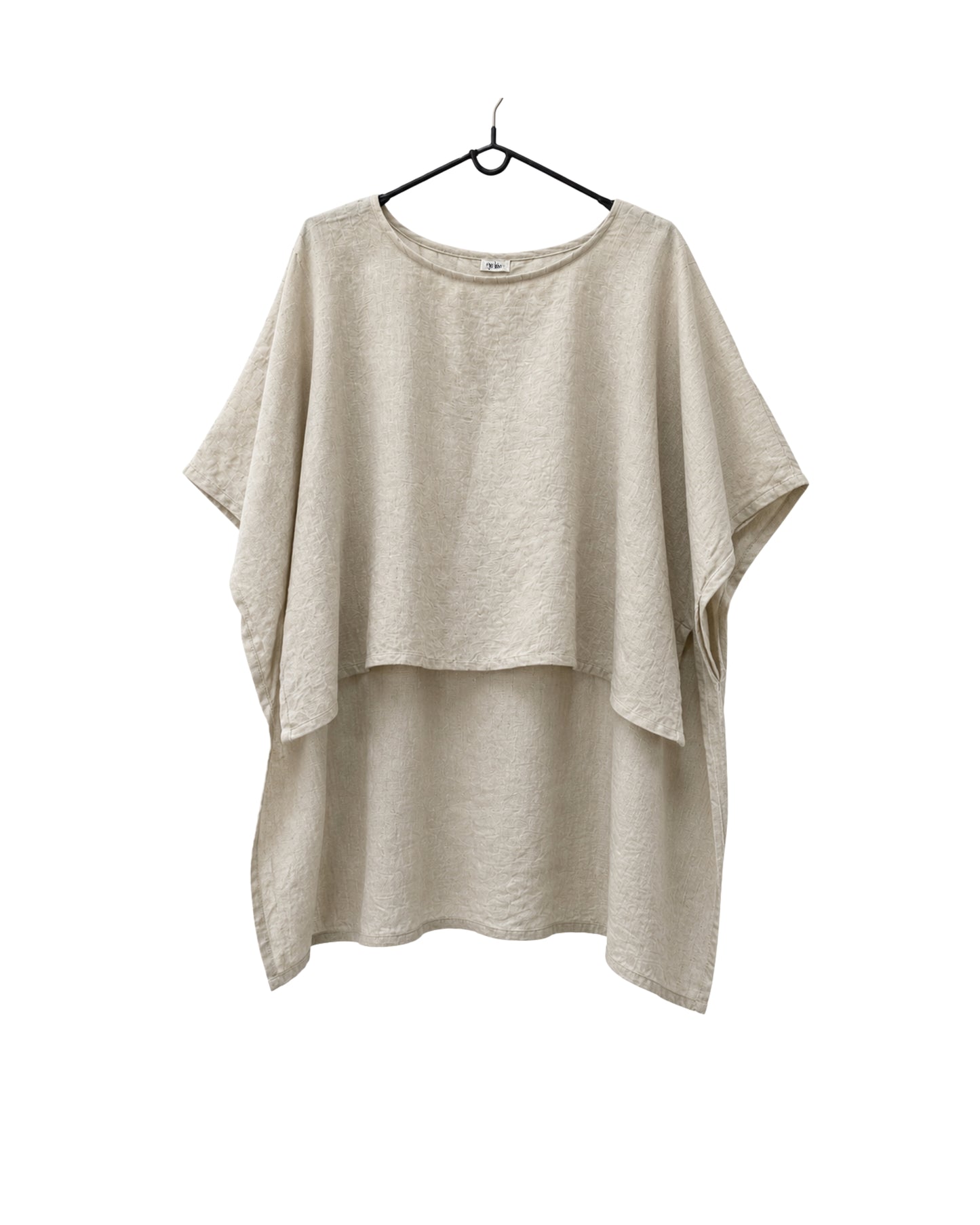 Jen Kahn long Tokyo linen tunic on a hanger with  short sleeves, hidden seam pockets and longer back hem in natural.