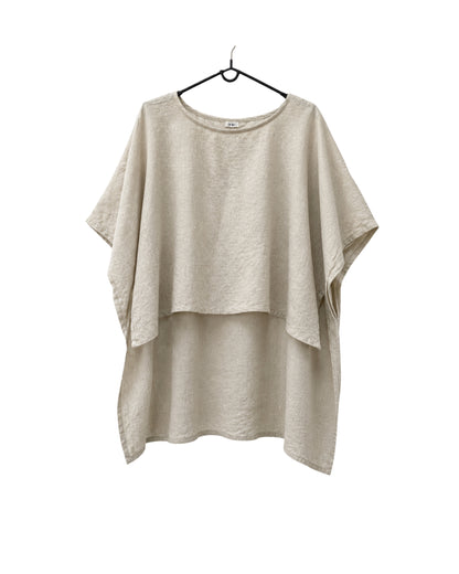 Jen Kahn long Tokyo linen tunic on a hanger with  short sleeves, hidden seam pockets and longer back hem in natural.