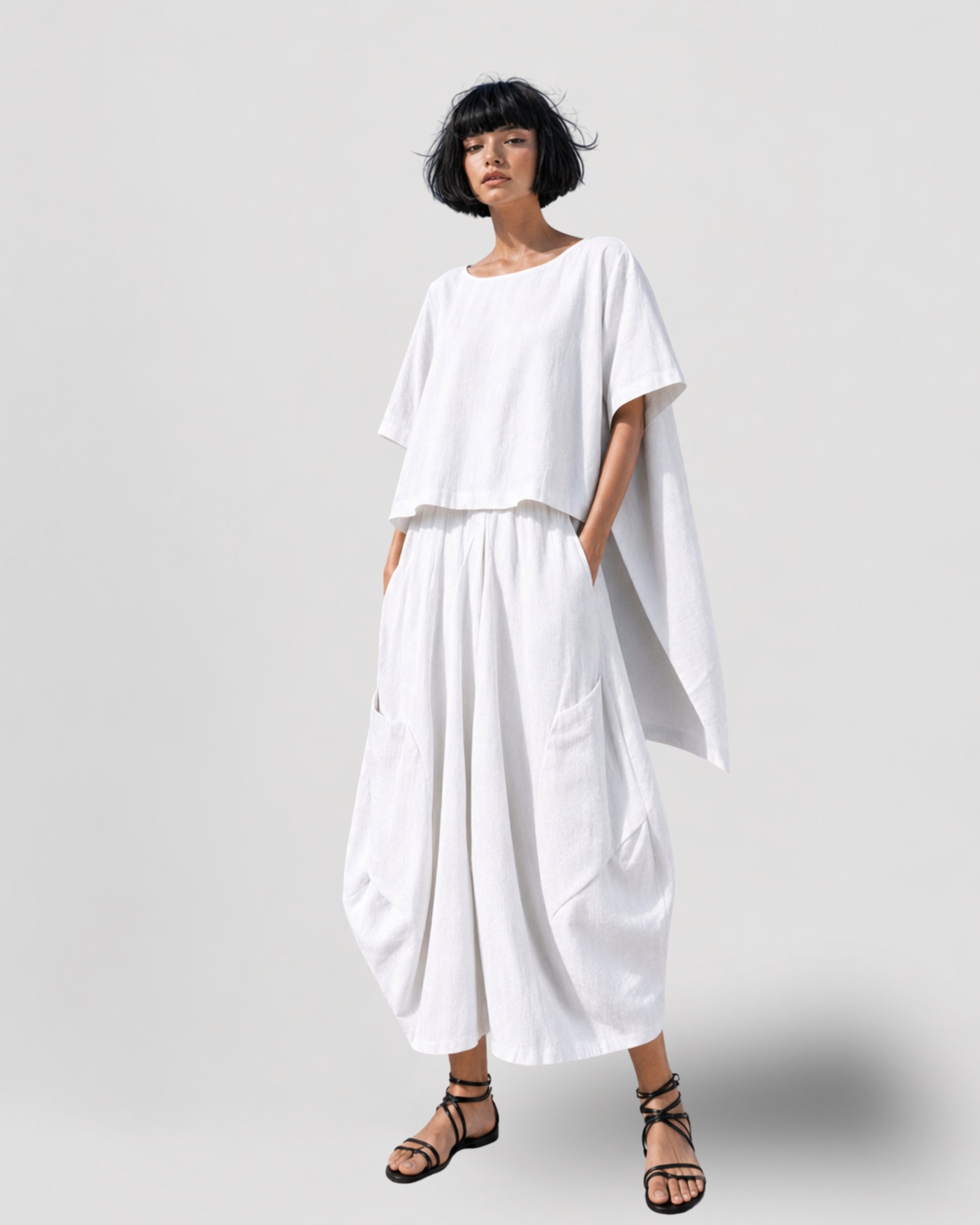Jen Kahn Samurai Linen Pants in White on model, made from pure linen with a relaxed barrel-leg silhouette, elasticated waistband and oversized patch pockets, paired with the Tokyo Linen Top in White.