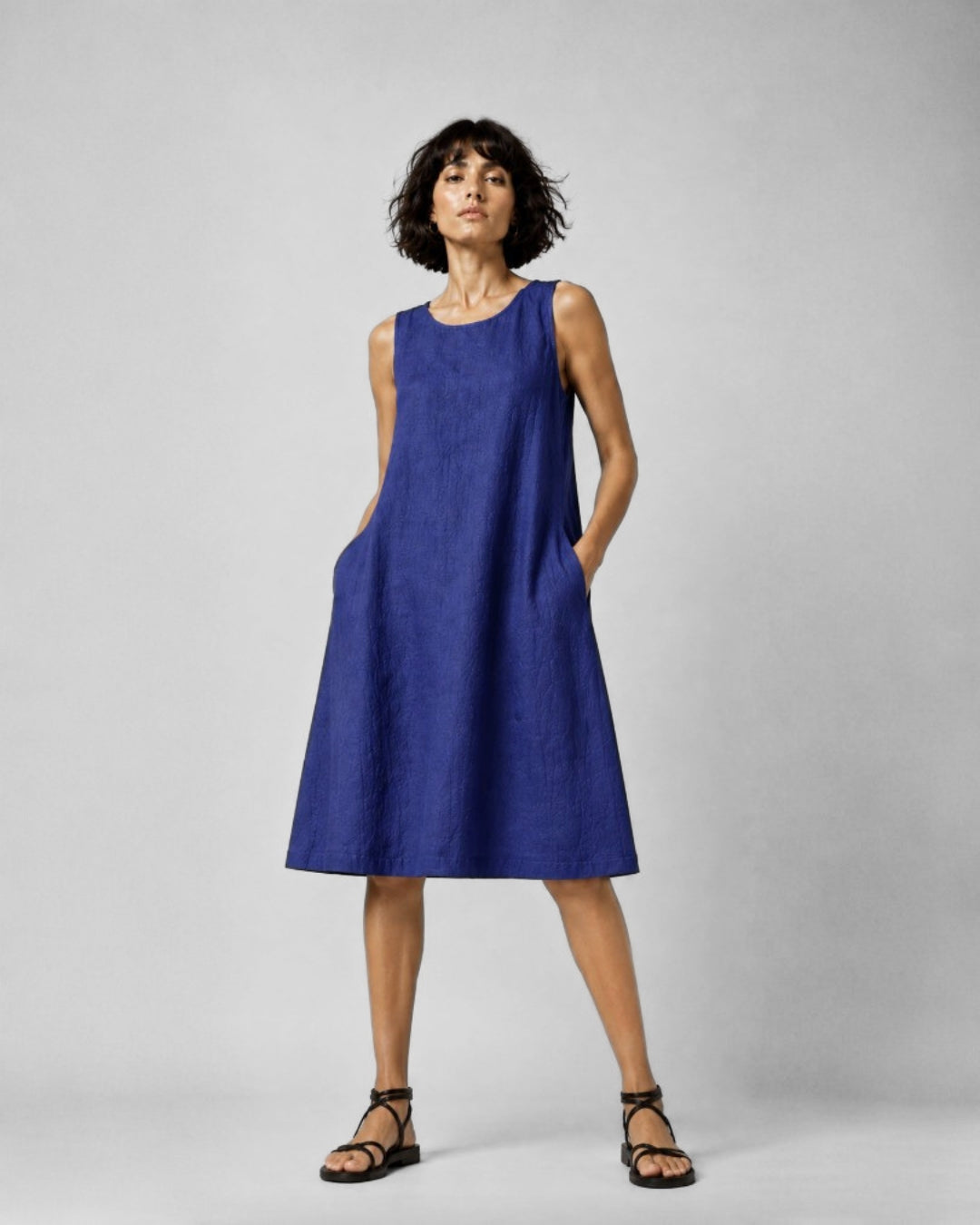 Jen Kahn Short Linen Dress in Indigo pure linen with a sleeveless design, rounded neckline, in-seam pockets and relaxed knee-length shape.