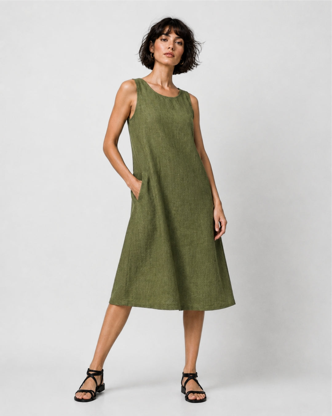 Jen Kahn Short Linen Dress in Pistachio pure linen with a sleeveless design, rounded neckline, in-seam pockets and knee-length shape.