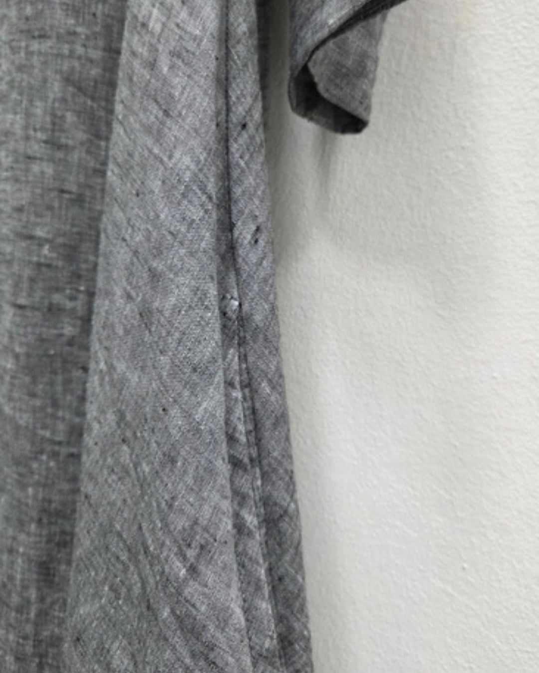 Close-up of the Jen Kahn Tokyo dress in grey mélange linen, showing the textured weave and side-seam pocket.