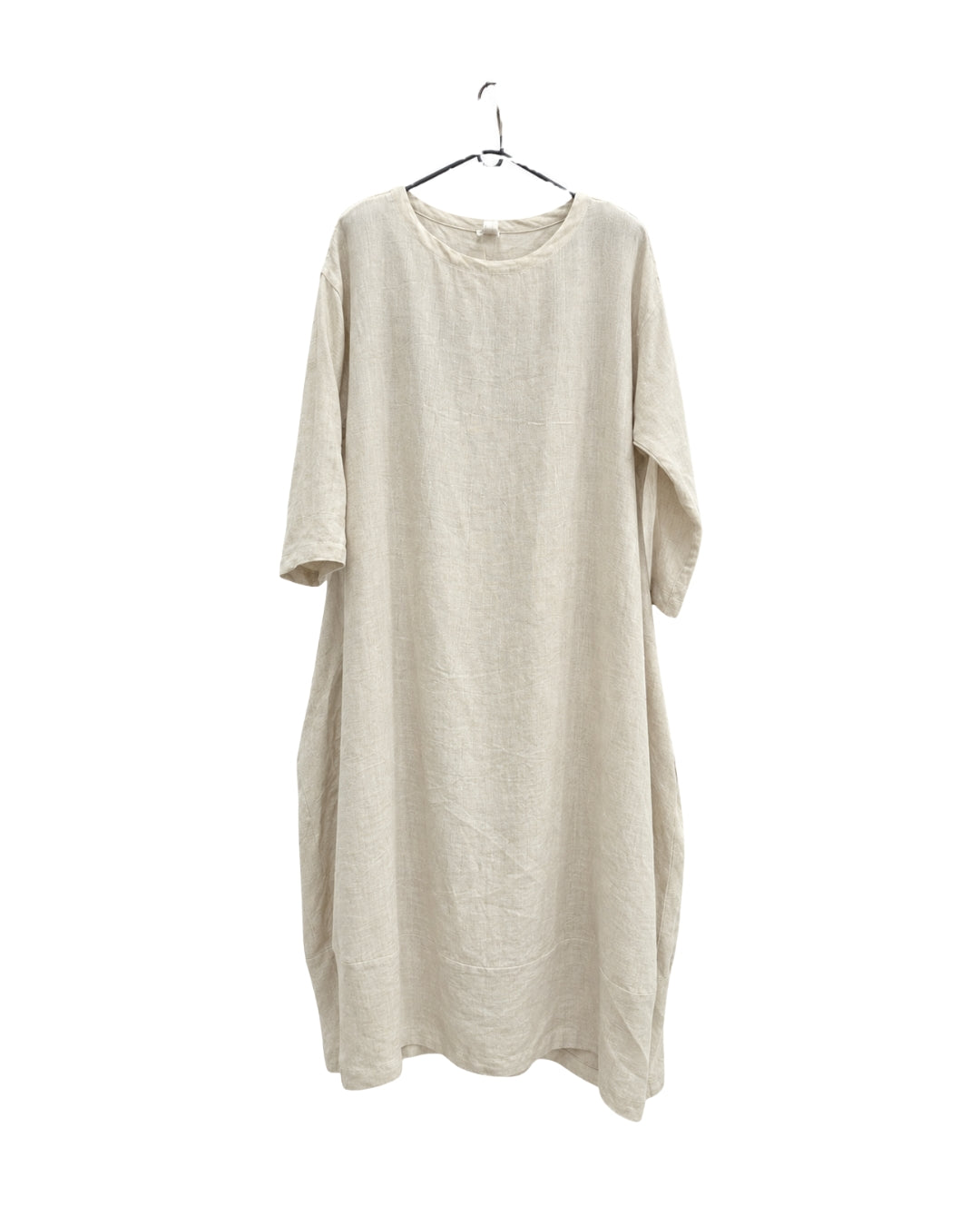 Jen Kahn Tokyo linen dress in natural on a hanger, showing its linen texture and relaxed drape.