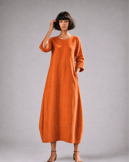 jen kahn Tokyo Linen Dress in Tangerine made from pure linen with a relaxed bell-shaped silhouette, round neckline, three-quarter sleeves and hidden seam pockets.