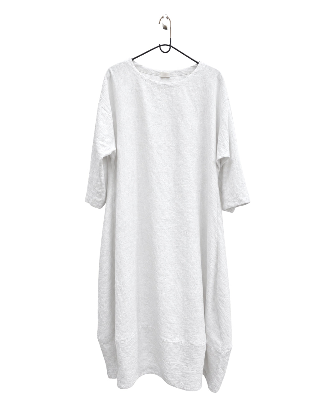 Jen Kahn Tokyo linen dress in white on a hanger, with a round neckline and three-quarter sleeves.