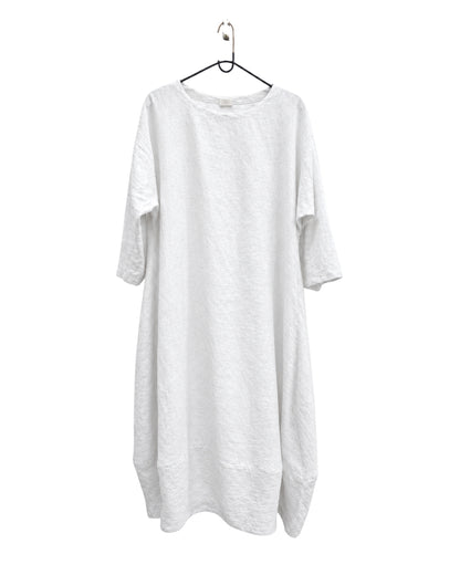 Jen Kahn Tokyo linen dress in white on a hanger, with a round neckline and three-quarter sleeves.