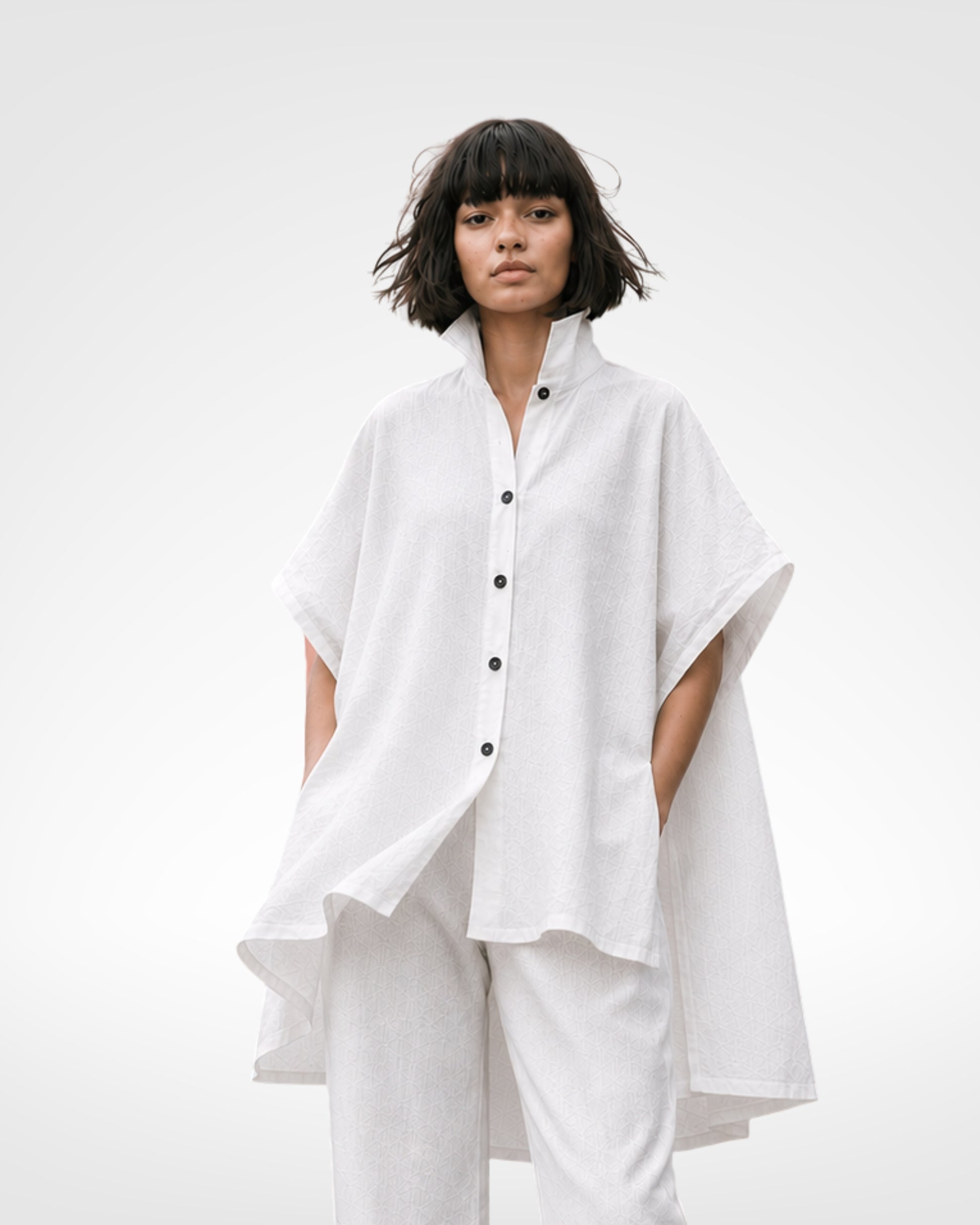 jen kahn Tokyo Linen Top in White made from pure linen with a high stand collar, button-through front, relaxed oversized silhouette and asymmetric high-low hem.