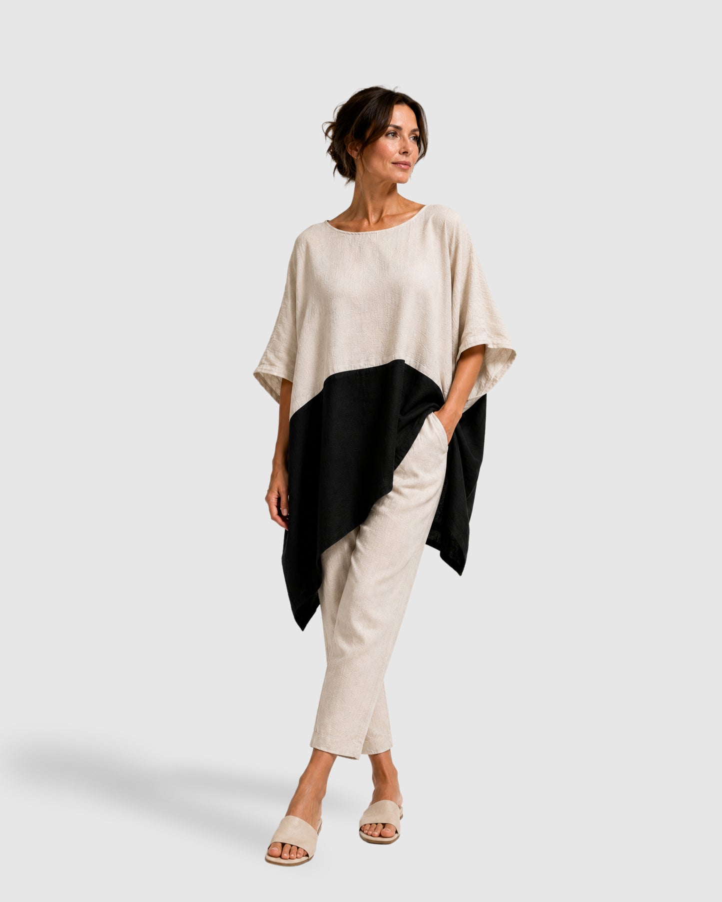 Model wearing the jen kahn Blocked Linen Top in natural and white pure linen with an asymmetric hem and contrast blocking design.