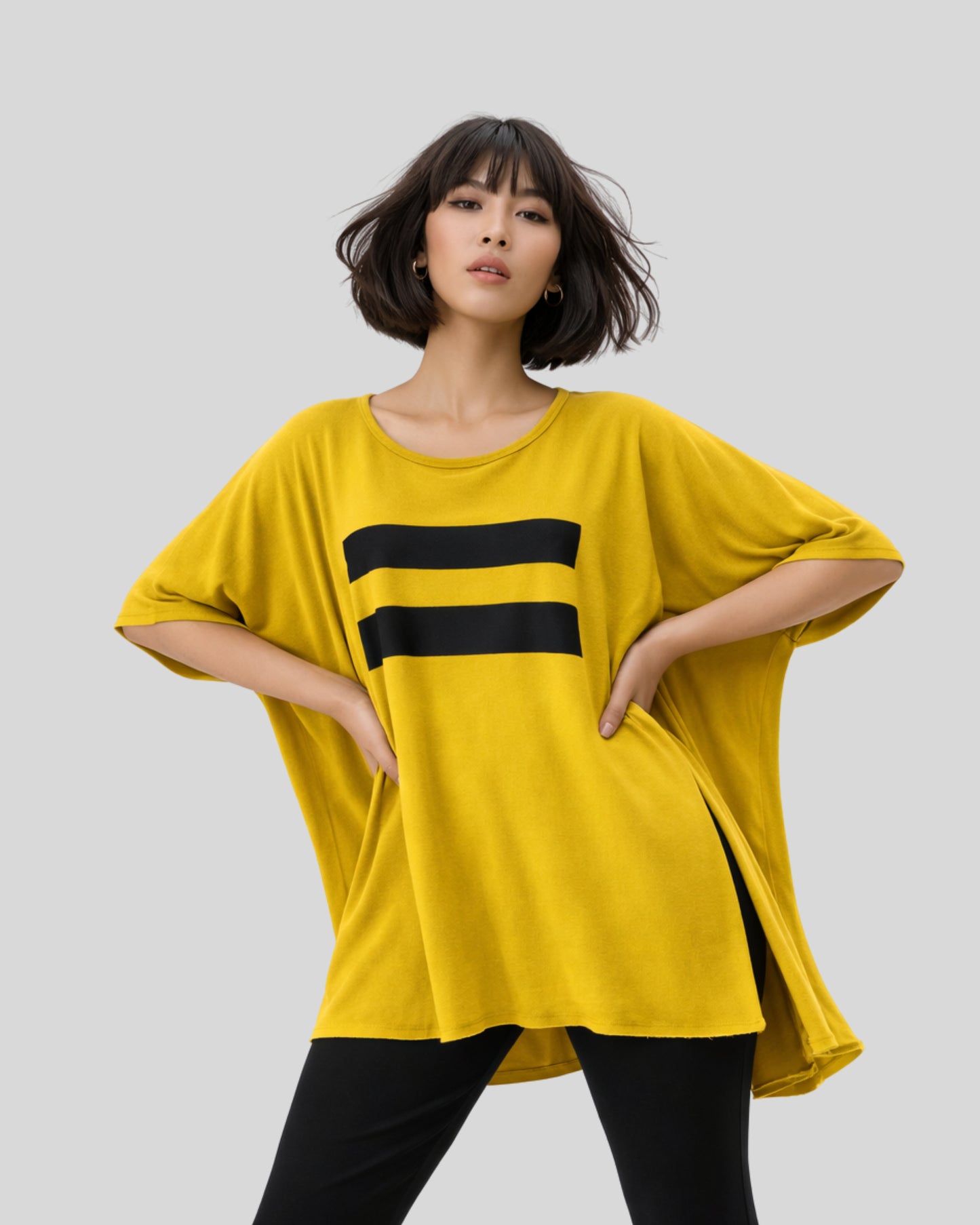 Model wearing the jen kahn Linear Jersey Knit Top in ochre with a black linear print and relaxed fit.